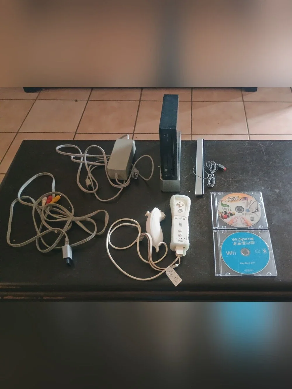 Nintendo Wii Bundle with 4 Games Black Console and White Controllers